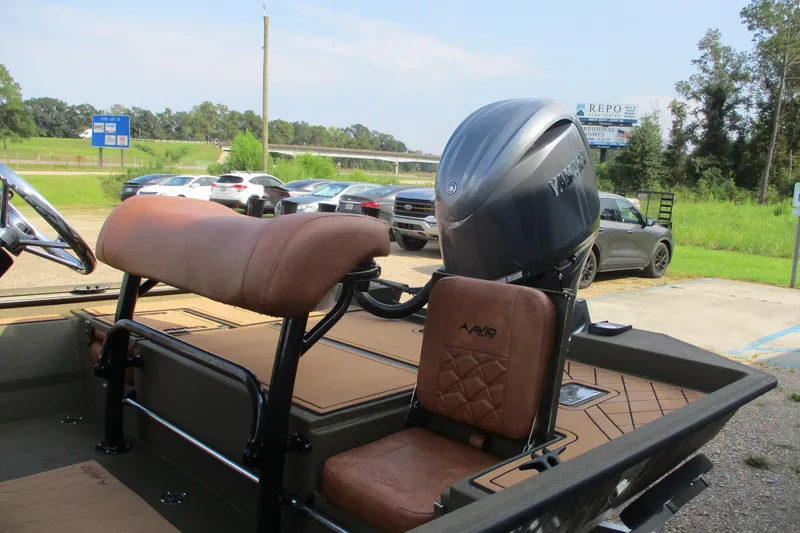 Slide: The Image of 2026 Avid 20 ROGUE CC boat with Yamaha engine, parked outdoors. - 18