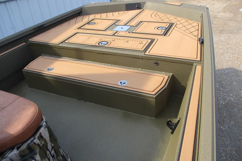 Slide: The Image of 2026 Avid 20 ROGUE CC boat interior with tan deck and storage compartments. - 5