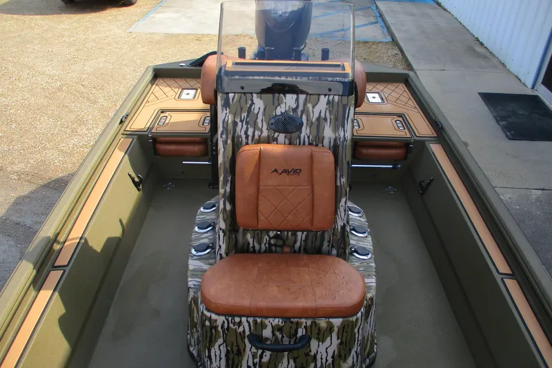 Slide: The Image of 2026 Avid 20 ROGUE CC boat interior with camo design and tan seating. - 9
