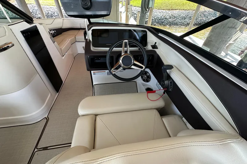 Slide: The Image of 2022 Regal LS6 boat cruising on a lake with passengers, showcasing sleek design and performance. - 10