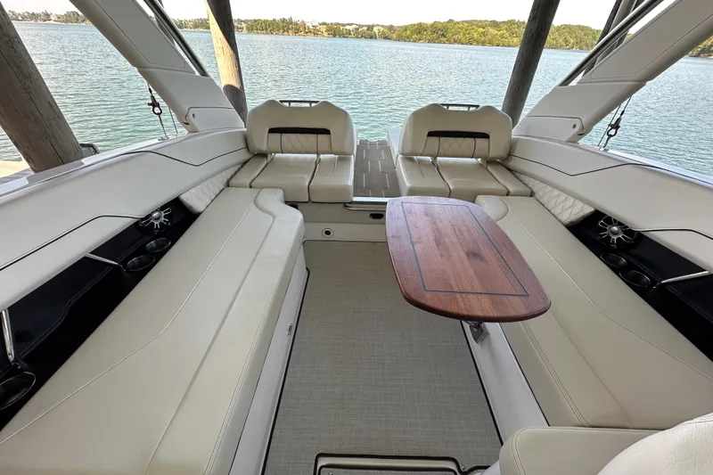Slide: The Image of 2022 Regal LS6 boat cruising on open water with two passengers. - 12