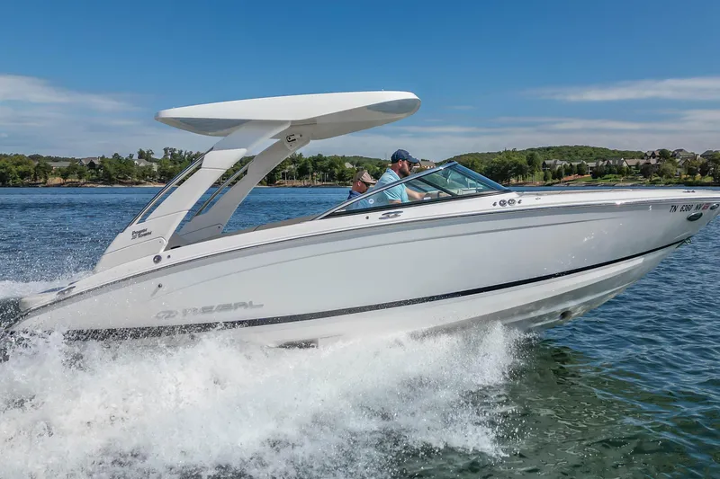 Slide: The Image of 2022 Regal LS6 boat cruising on a sunny day, creating splashes in the water. - 18