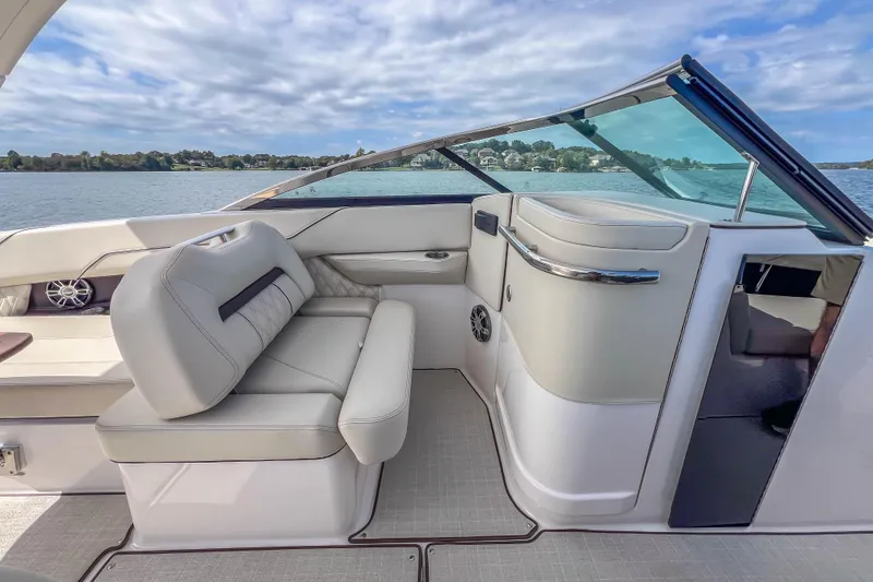 Slide: The Image of 2022 Regal LS6 boat interior with luxurious seating and scenic water view. - 26