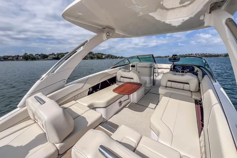 Slide: The Image of Luxurious 2022 Regal LS6 boat interior with spacious seating and elegant design on a sunny day. - 28