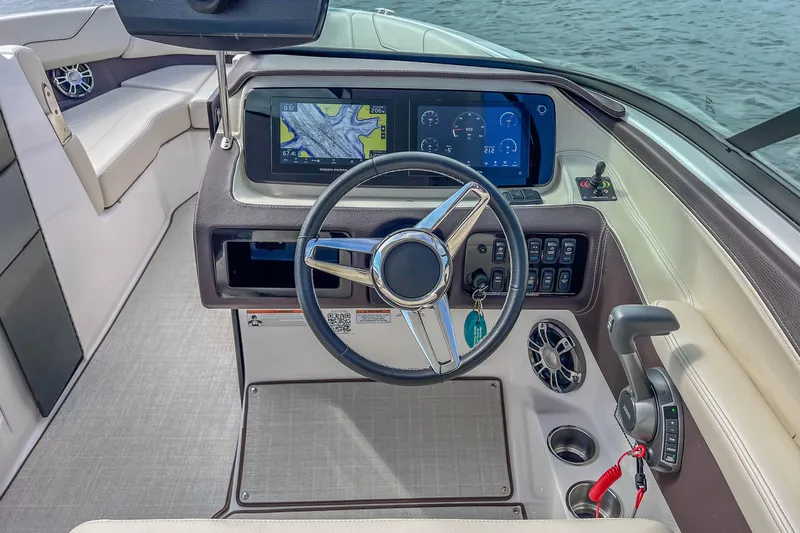 Slide: The Image of 2022 Regal LS6 boat dashboard with steering wheel, digital displays, and controls. - 30