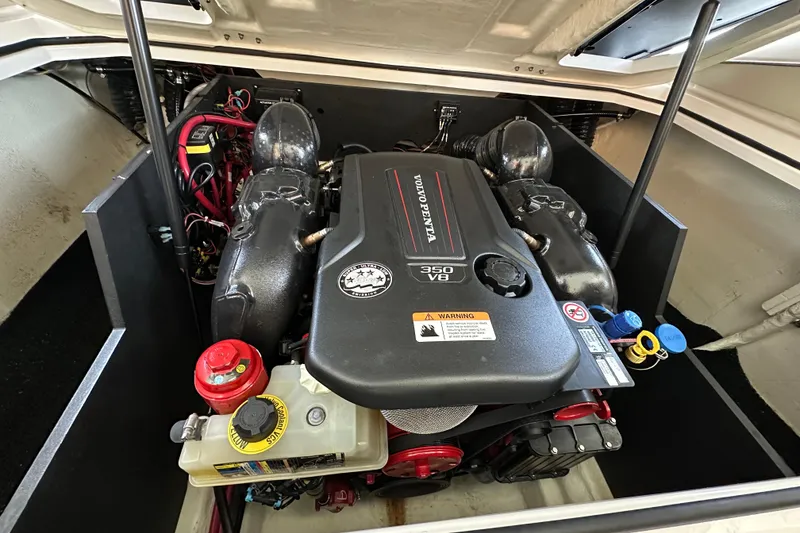 Slide: The Image of 2022 Regal LS6 boat cruising on a scenic lake under a clear blue sky. - 4