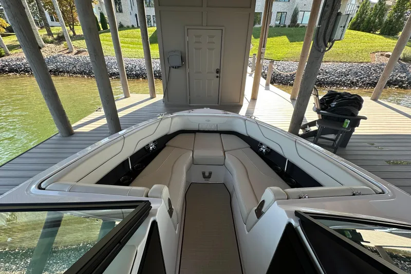 Slide: The Image of 2022 Regal LS6 boat cruising on a serene lake under a clear blue sky. - 5