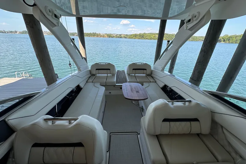 Slide: The Image of 2022 Regal LS6 boat cruising on a scenic lake with two passengers. - 7