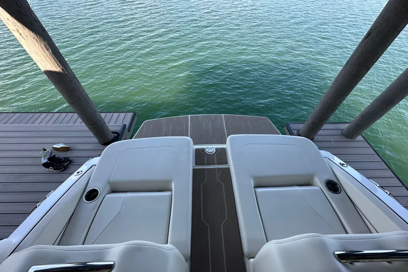 Slide: The Image of 2022 Regal LS6 boat cruising on a scenic lake with two passengers. - 8