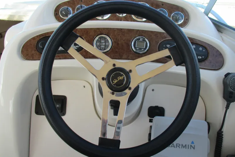Slide: The Image of Steering wheel of a 2000 Sea Ray 240 Sundancer boat with dashboard controls. - 10