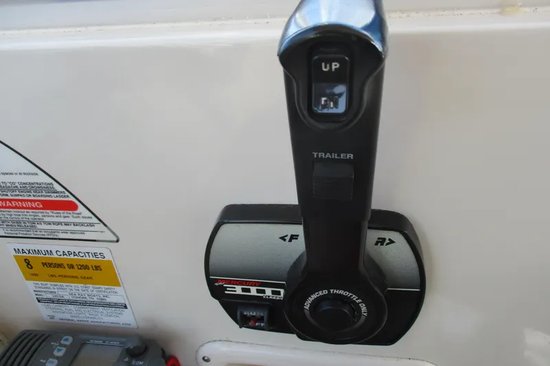 Slide: The Image of Throttle control of 2000 Sea Ray 240 Sundancer boat, showing capacity and warning labels. - 12