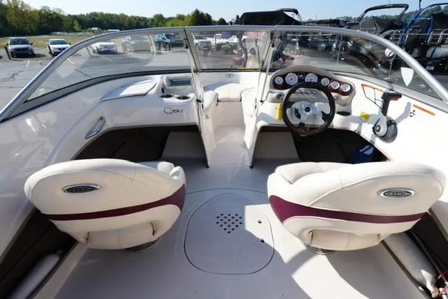 Slide: The Image of 2011 Tahoe Q5SI boat interior with dual seats and dashboard controls. - 10