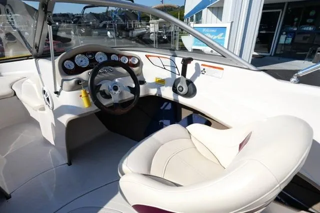 Slide: The Image of Interior of a 2011 Tahoe Q5SI boat with steering wheel and dashboard controls. - 11