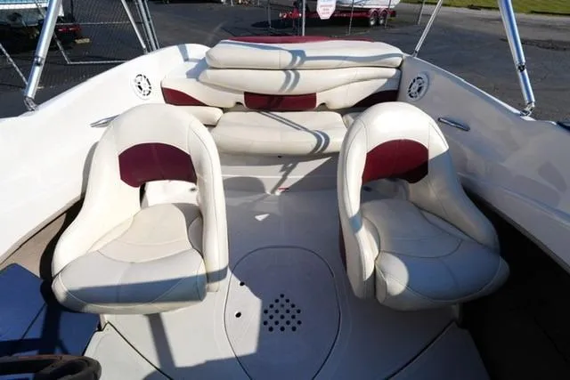Slide: The Image of 2011 Tahoe Q5SI boat interior with white and maroon seating arrangement. - 13
