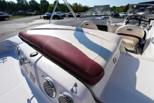 Slide: The Image of 2011 Tahoe Q5SI boat interior with maroon and white seating, dashboard, and speakers. - 14