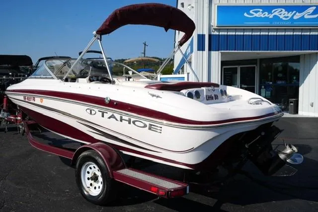 Slide: The Image of 2011 Tahoe Q5SI boat on trailer outside dealership. - 5