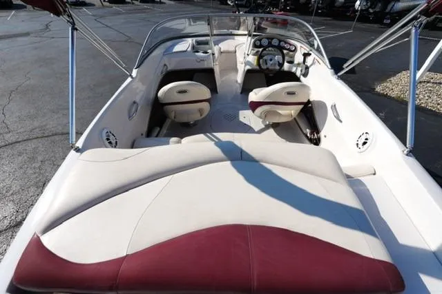 Slide: The Image of 2011 Tahoe Q5SI boat interior with white and maroon seating, dashboard view. - 6