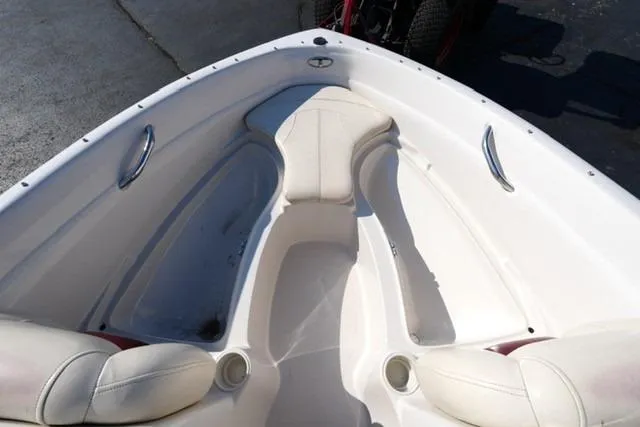 Slide: The Image of 2011 Tahoe Q5SI boat interior with white seating and stainless steel handles. - 8
