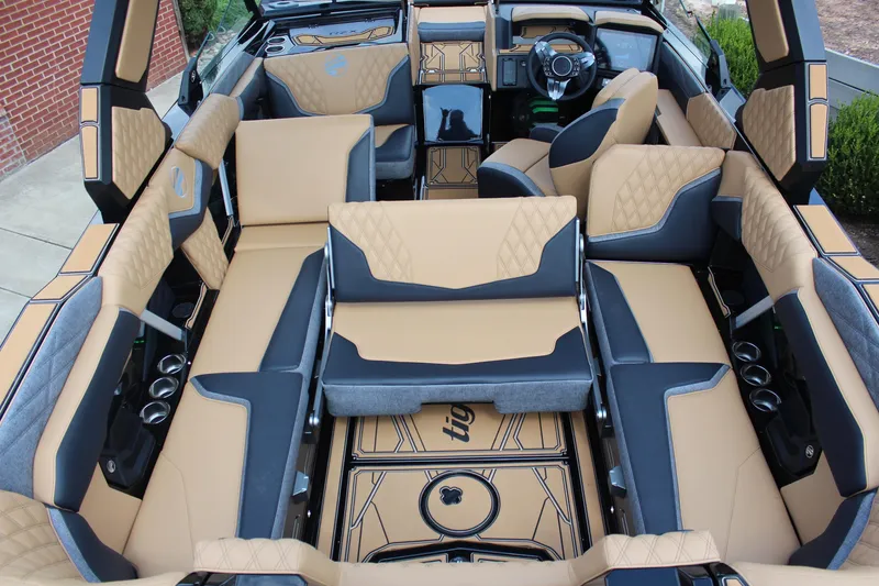 Slide: The Image of Luxurious interior of 2026 Tigé 24RZX boat with tan and gray seating. - 11