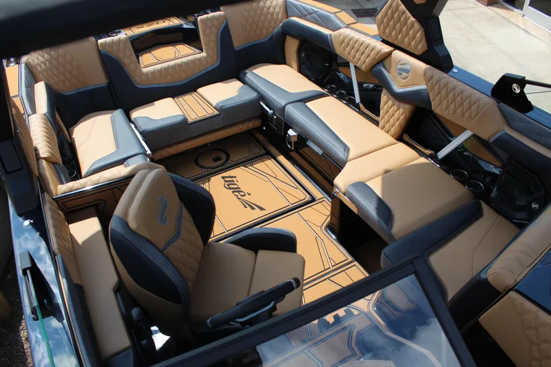 Slide: The Image of Luxurious interior of 2026 Tigé 24RZX boat with tan and black seating. - 12