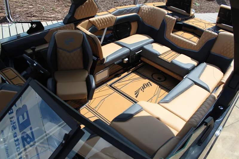 Slide: The Image of Luxurious interior of 2026 Tigé 24RZX boat with tan and black seating. - 13