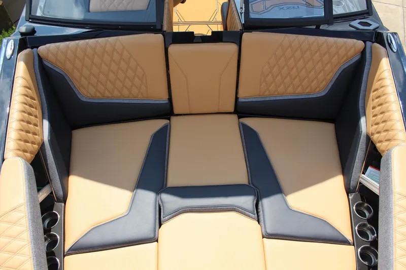 Slide: The Image of Luxurious interior of 2026 Tigé 24RZX boat with tan and black seating. - 14