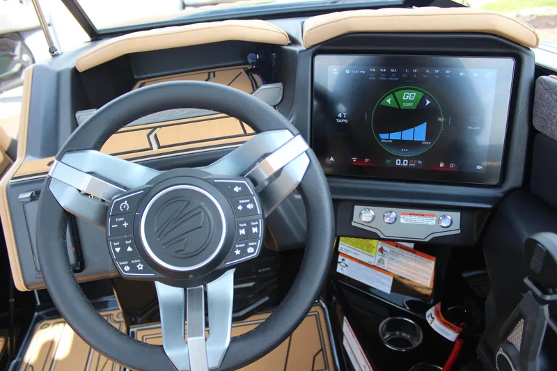 Slide: The Image of Steering wheel and touchscreen of 2026 Tigé 24RZX boat, showcasing modern controls. - 18