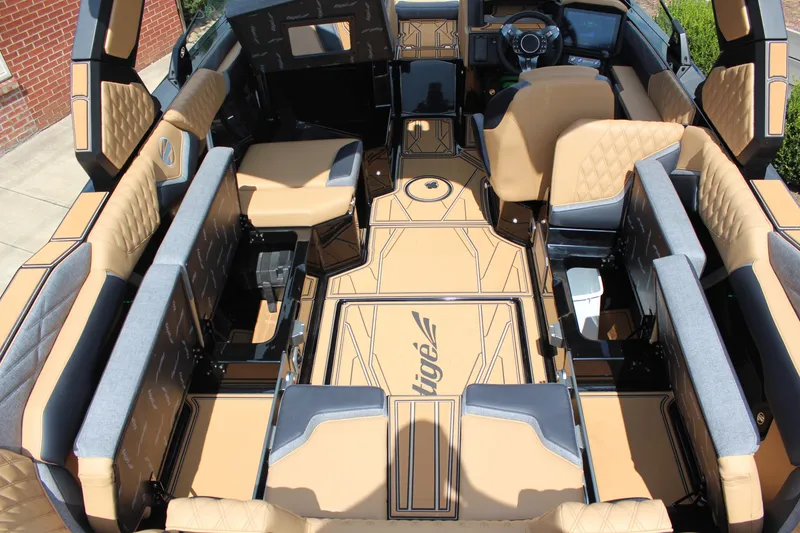 Slide: The Image of Luxurious interior of 2026 Tigé 24RZX boat with tan and gray seating. - 19