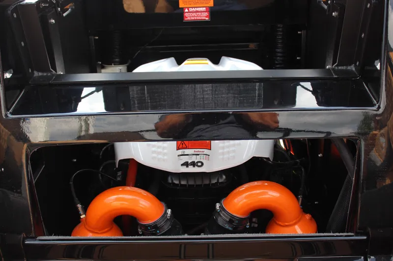 Slide: The Image of Engine compartment of 2026 Tigé 24RZX boat with orange components and warning labels. - 22