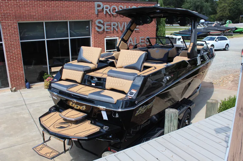 Slide: The Image of 2026 Tigé 24RZX boat with luxurious seating, displayed at a dealership. - 3