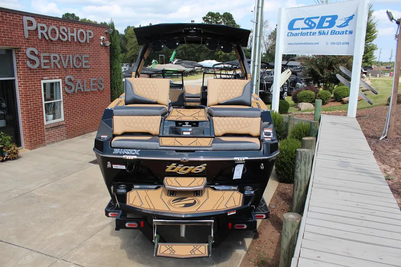 Slide: The Image of 2026 Tigé 24RZX boat at Charlotte Ski Boats dealership, showcasing luxury seating and design. - 4