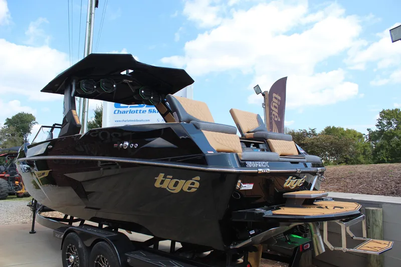 Slide: The Image of 2026 Tigé 24RZX boat with sleek black design and tan seating on display. - 5
