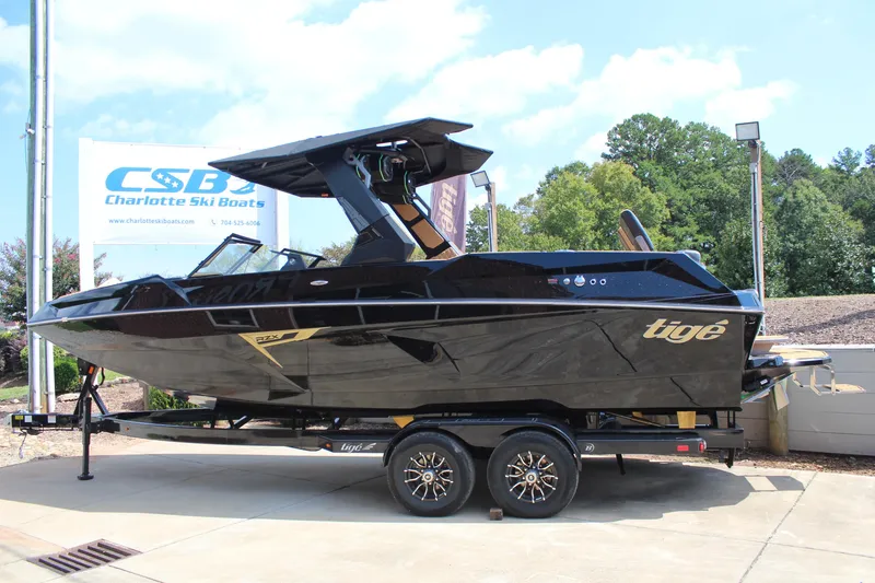 Slide: The Image of 2026 Tigé 24RZX boat in black, displayed at Charlotte Ski Boats dealership. - 6