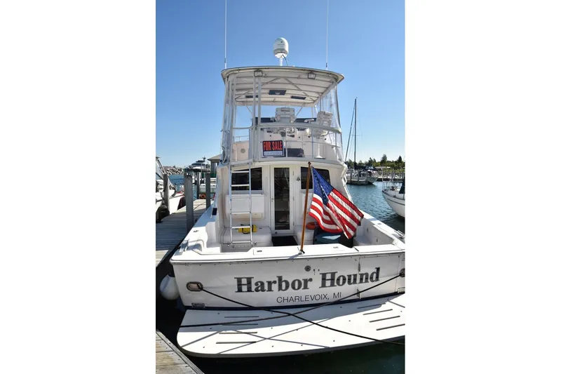 Slide: The Image of 1996 Bertram 36' Convertible boat docked, displaying American flag, "Harbor Hound" name visible. - 3
