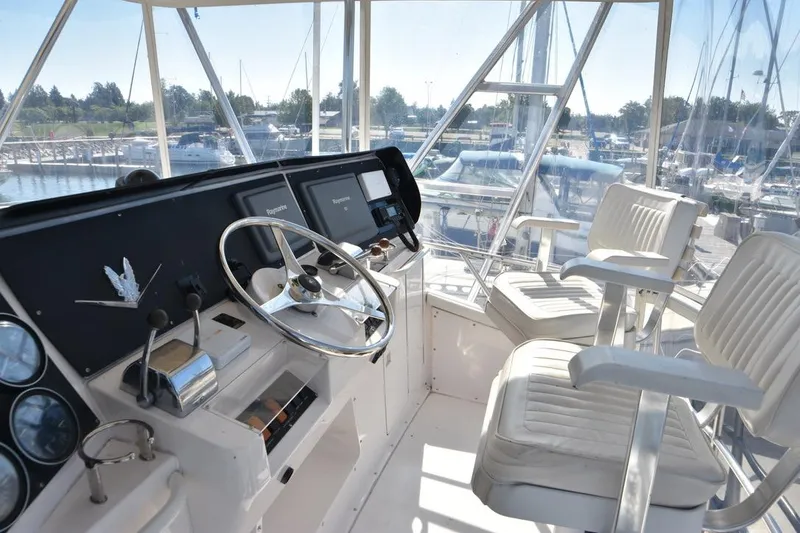Slide: The Image of Interior view of a 1996 Bertram 36' Convertible yacht cockpit with steering wheel and seats. - 4
