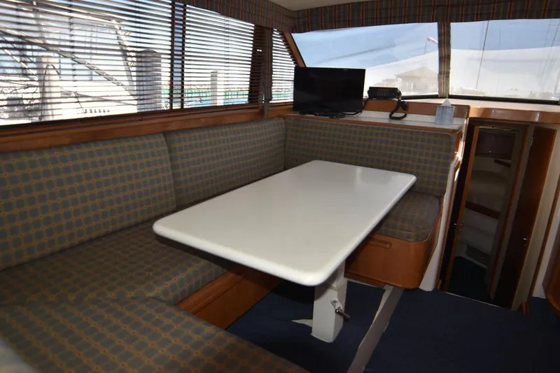 Slide: The Image of Interior of a 1996 Bertram 36' Convertible yacht with dining area and TV. - 8