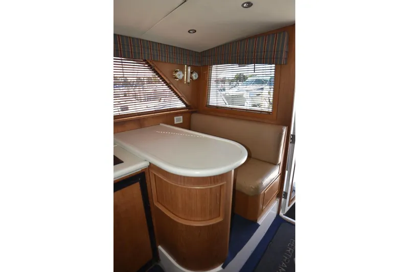 Slide: The Image of Interior of 1996 Bertram 36' Convertible yacht with seating and window blinds. - 9
