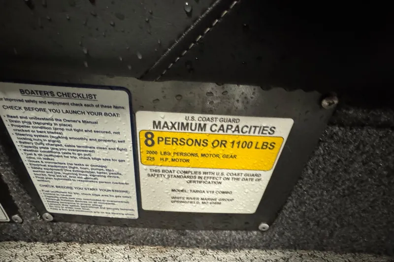 Slide: The Image of 2024 Tracker Targa V-19 Combo capacity label, 8 persons or 1100 lbs, U.S. Coast Guard compliant. - 11