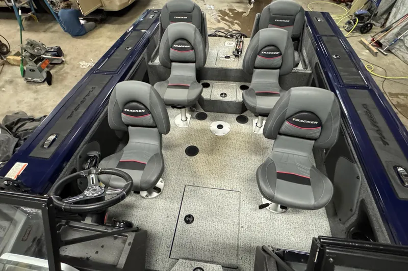 Slide: The Image of 2024 Tracker Targa V-19 Combo with Minn Kota PowerDrive motor in a garage setting. - 15