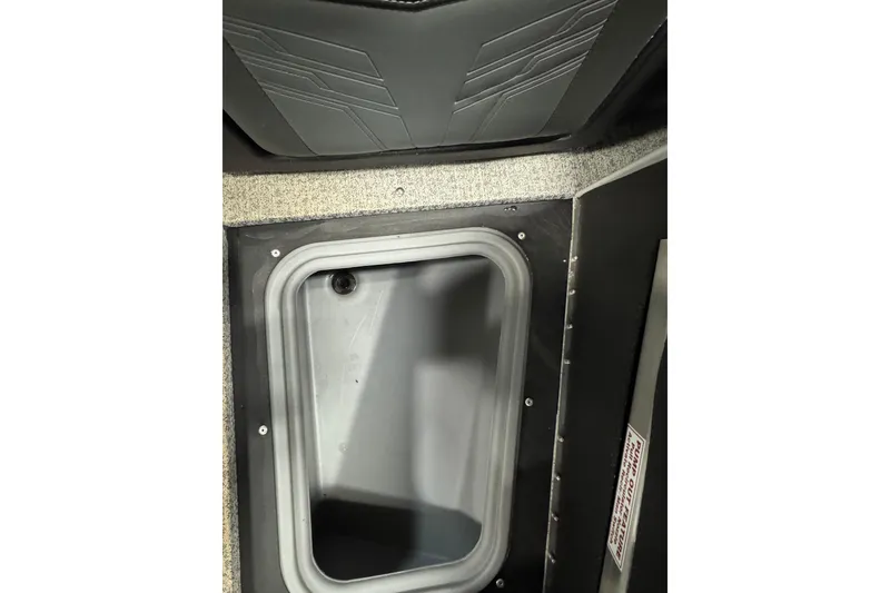 Slide: The Image of 2024 Tracker Targa V-19 Combo boat storage compartment with textured interior design. - 19