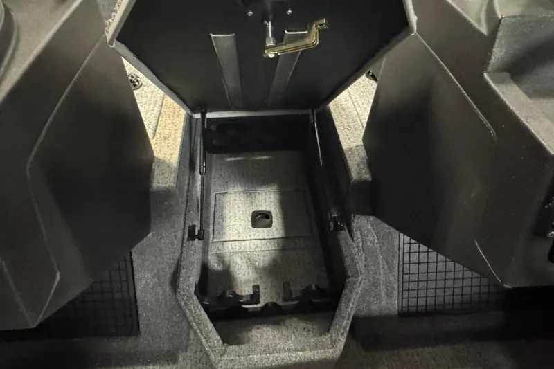 Slide: The Image of 2024 Tracker Targa V-19 Combo boat storage compartment with open lid. - 20