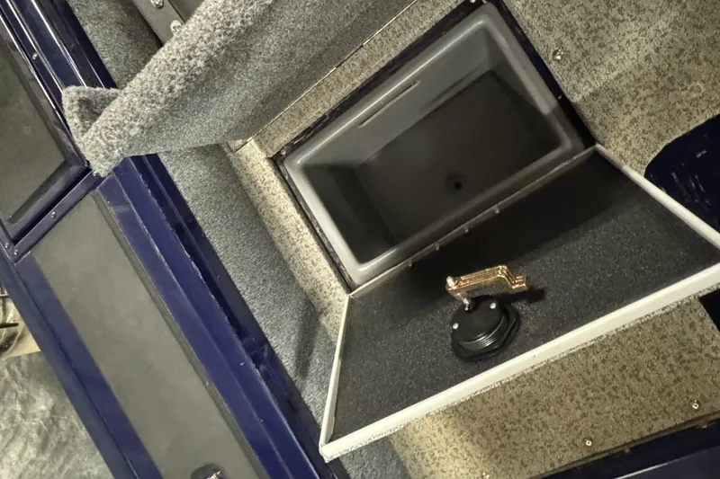 Slide: The Image of 2024 Tracker Targa V-19 Combo boat interior storage compartment with open lid. - 22