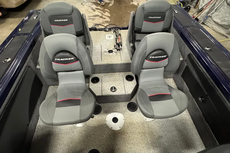 Slide: The Image of 2024 Tracker Targa V-19 Combo boat interior with four gray seats and cup holders. - 6
