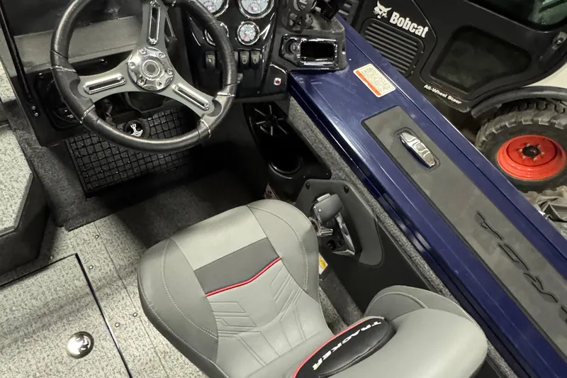 Slide: The Image of 2024 Tracker Targa V-19 Combo dashboard with steering wheel and Lowrance display. - 8