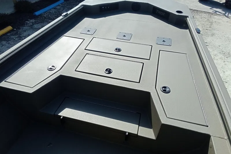 Slide: The Image of 2025 Thor 1900 Lake Hammer boat deck with storage compartments. - 13