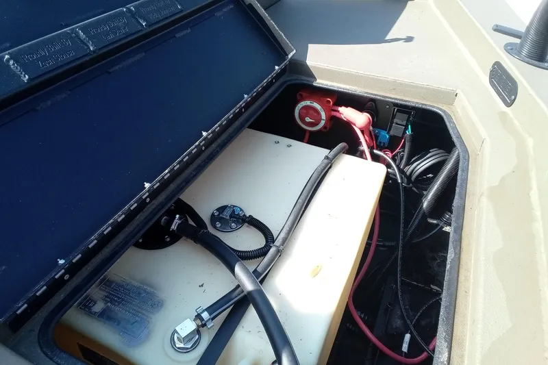 Slide: The Image of Open storage compartment of 2025 Thor 1900 Lake Hammer boat, showing battery and wiring. - 8