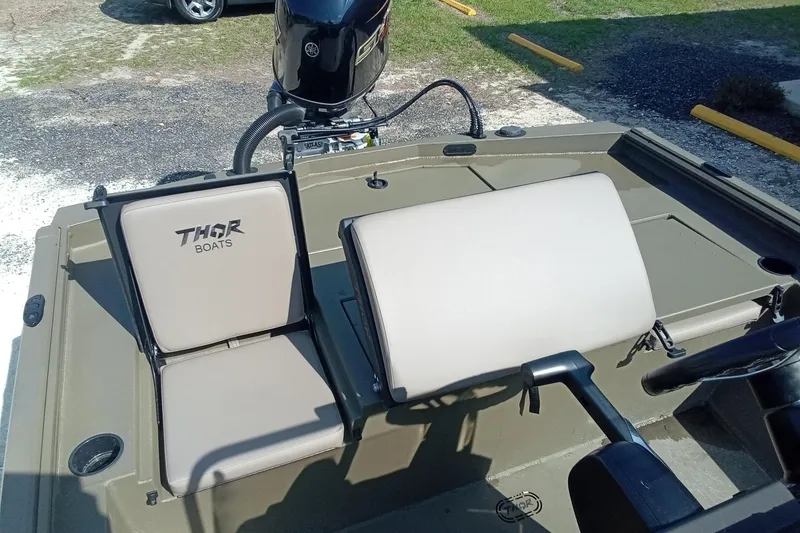 Slide: The Image of 2025 Thor 1900 Lake Hammer boat interior with beige seats and steering wheel. - 9