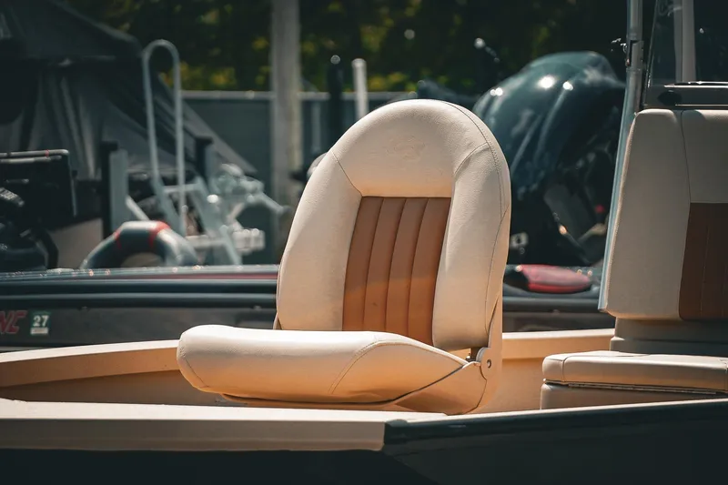 Slide: The Image of 2025 G3 Bay 19 GX boat seat, beige and brown, in a marina setting. - 10