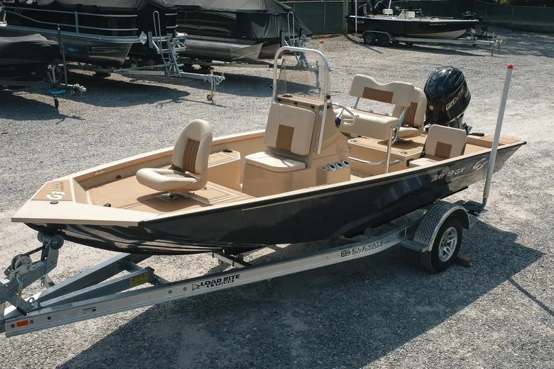 Slide: The Image of 2025 G3 Bay 19 GX boat on trailer, parked in a gravel lot. - 28