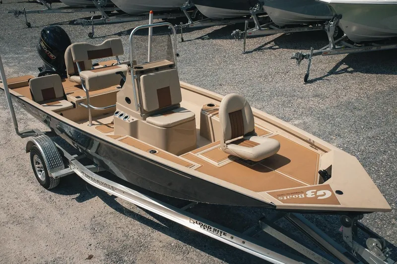 Slide: The Image of 2025 G3 Bay 19 GX boat on trailer, featuring beige seating and sleek design. - 3